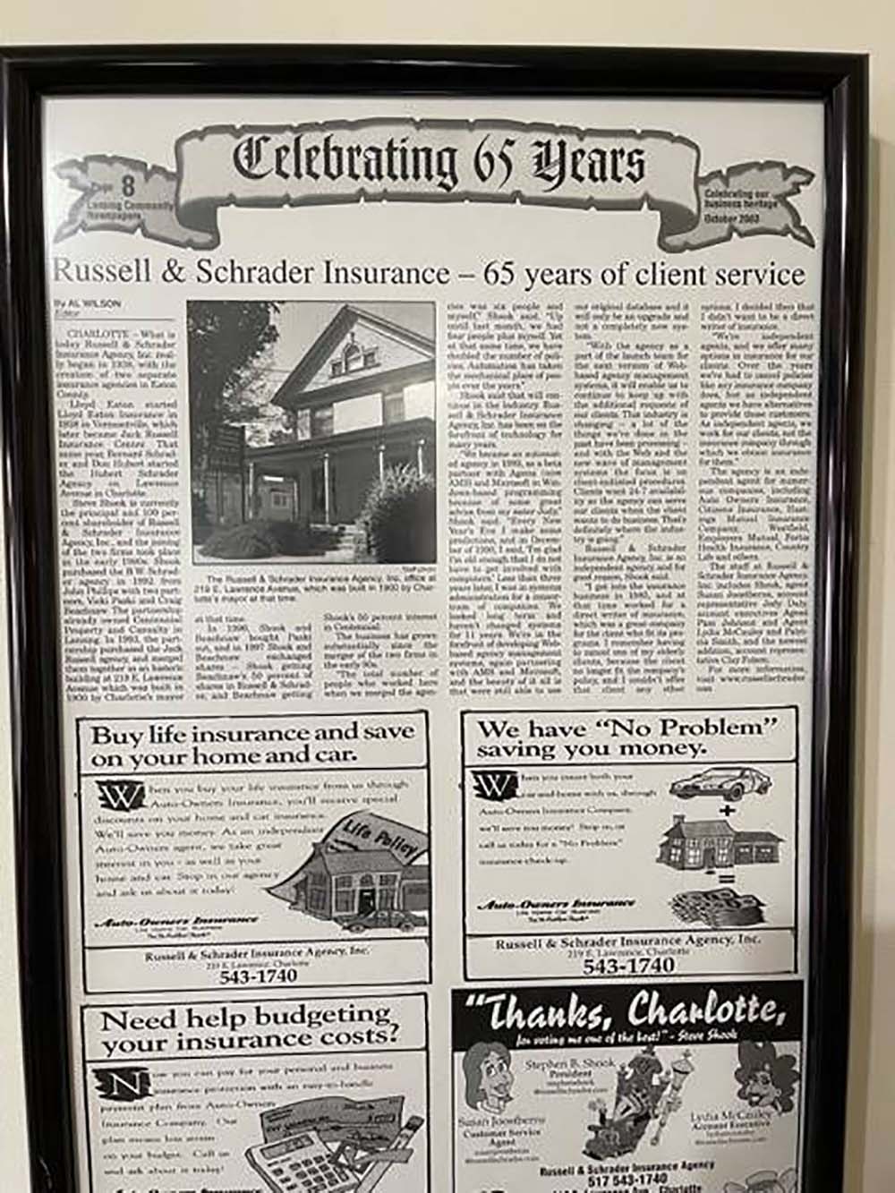 Our History - Old Framed Newspaper Article Featuring Russell & Schrader Insurance with Image of Office Building